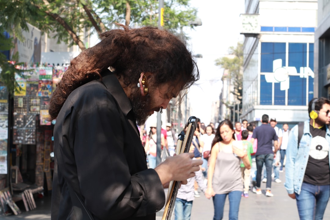 ❓ Your Burning Questions Answered: FAQ on Gaming Downloads by Games Like man in black suit playing guitar